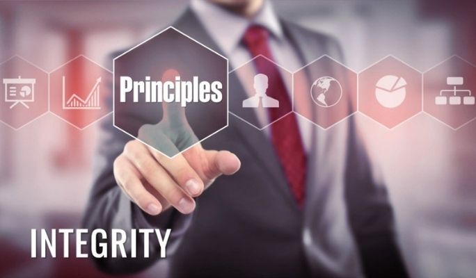 Decorative image of a man in a suit pressing on a hologram bottom with the word "principles" in front of him in the image foreground. Below this, the principle "Integrity" is written in bold overtop the image in the bottom left corner.