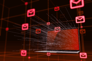 A laptop surrounded by glowing red email icons, with digital lines illustrating data flow or email traffic emerging from the screen.