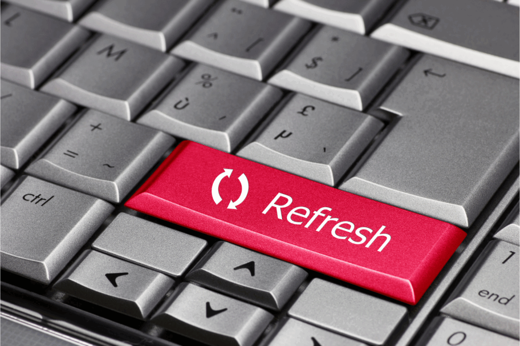 Close-up of a computer keyboard with a red key labeled “Refresh” replacing the Enter key.